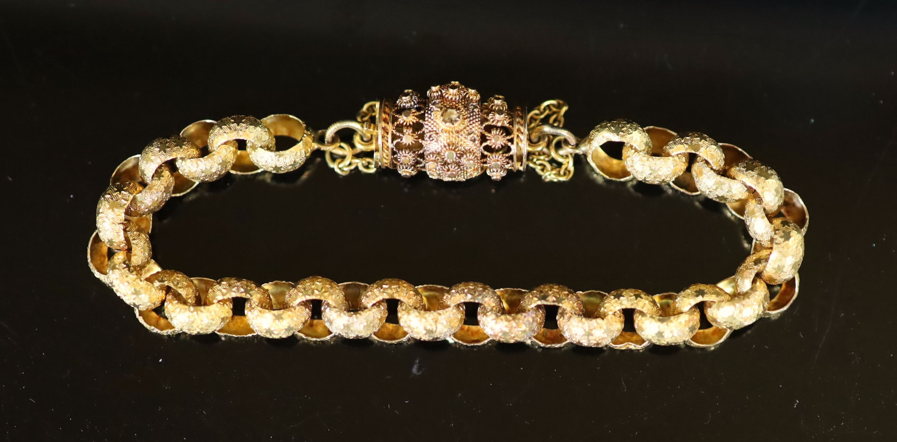 A 19th century star engraved belcher link bracelet, with pierced cannettile work, barrel shaped clasp